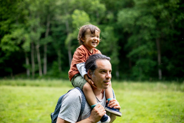 istock Happy Young Boy on His Fathers Shoulders 1267342772