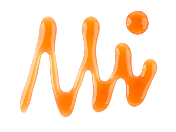 istock Maple syrup drizzle isolated on white background. Splashes of sweet maple syrup. Top view. 1267344360
