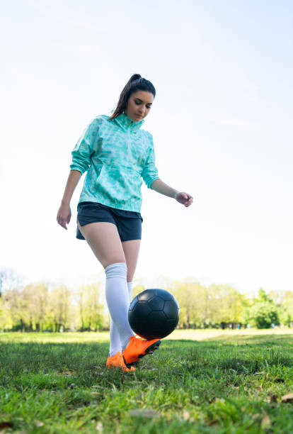 istock Young woman practicing soccer skills with ball. 1267345212