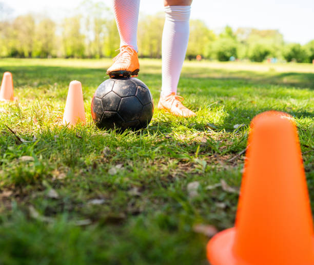 istock Young female soccer player practicing on field. 1267345221