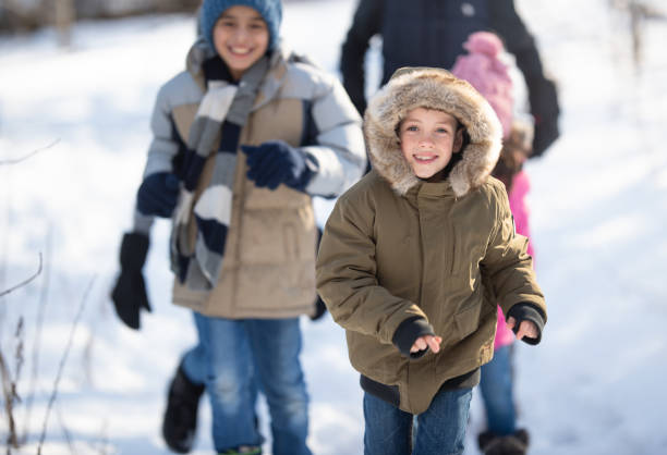 istock Kids playing in the snow 1267346298