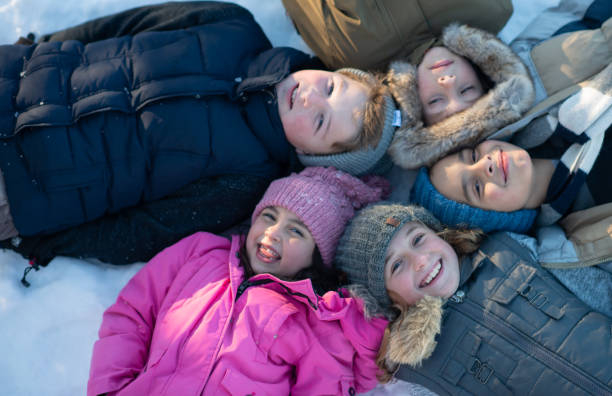 istock Kids playing in the snow 1267346331