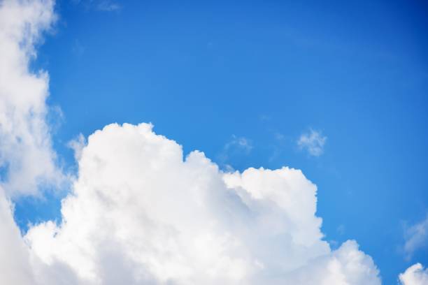 istock Beautiful white soft fluffy clouds on a blue sky background 1267347983