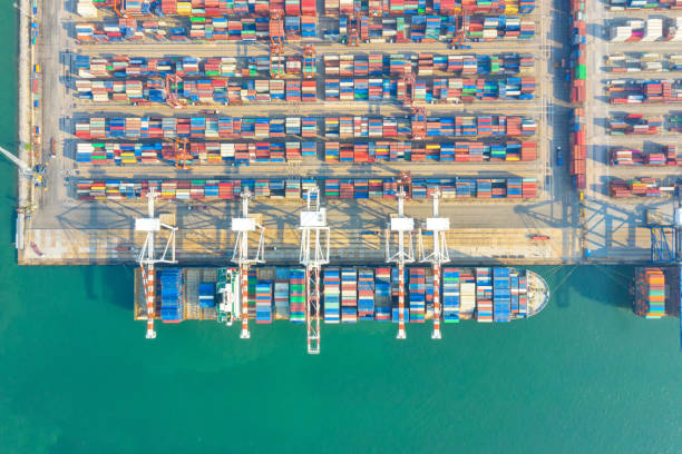 istock Container , container ship in export and import business and logistics. Shipping cargo to harbor by crane. Water transport International. Aerial view and top view. 1267353407