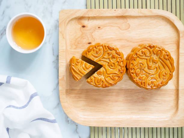 istock Mooncakes on a wooden plate with a cup of tea 1267355852