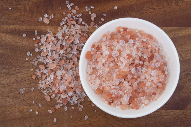 istock Himalayan salt in white bowl on wooden background 1267356906