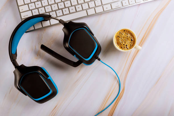 istock Call center support table with headset headphones with microphone, keyboard top view coffee espresso 1267359311