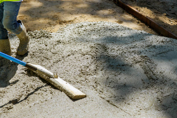 istock Laying down a new sidewalk in wet concrete on freshly poured sidewalks 1267359313