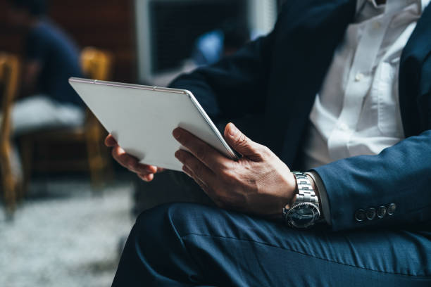 business man hands holding tablet stock photo - note pad desk office meeting imagens e fotografias de stock