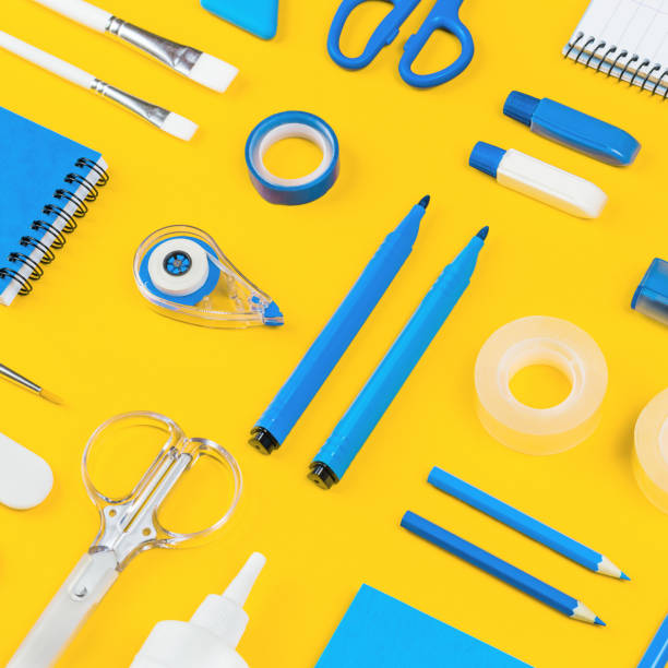 istock Assorted office and school white and blue stationery on yellow 1267361093