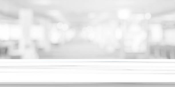 abstract blur inside office with modern white marble table perspective for show ads or promote product and content on display concept