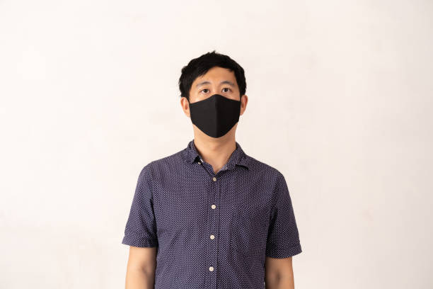 istock Asian man wearing face mask facing camera, studio shot 1267369736