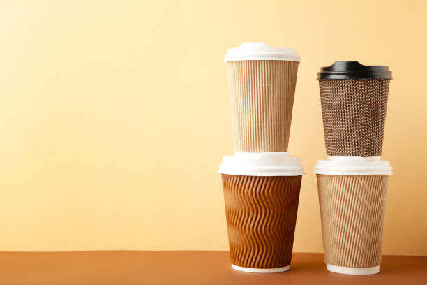 istock Many brown cups of coffee on beige background. 1267369805