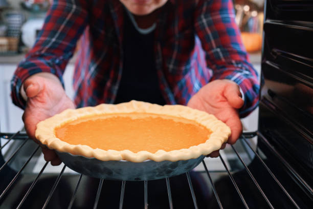 istock Baking Pumpkin Pie for the Holidays in the Oven 1267370676