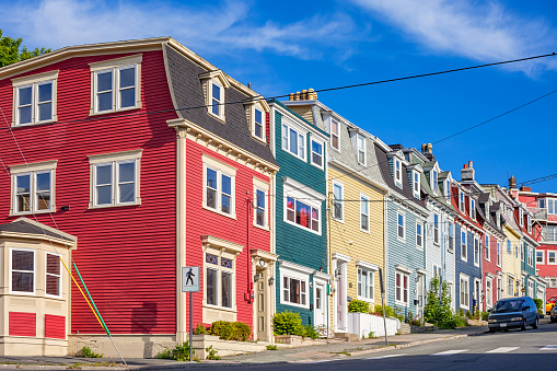 Traditional, colorful houses on a sloped street in St John's Newfoundland Canada on a sunny day