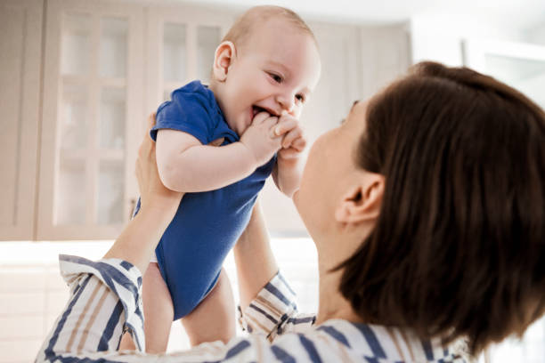 istock Baby in his mothers arms 1267377338