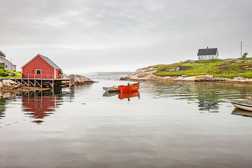 Colorful fishing boats in Inner Harbor and Prospect Harbor Point lighthouse, Maine Atlantic shore, USA