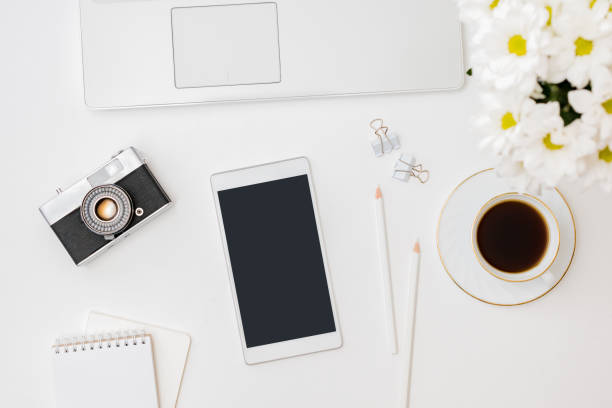 istock Flat lay mockup smartphone blank screen, laptop a cup of coffee on a white background 1267377791