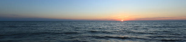 istock colorful sea sunset and orange sun 1267379700
