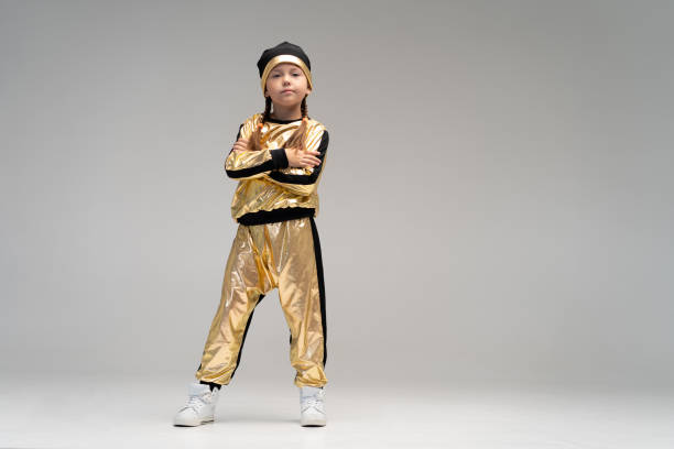 happy little girl in gold suit dancing isolated on white background. - gymnastics smiling little girls only isolated on white imagens e fotografias de stock