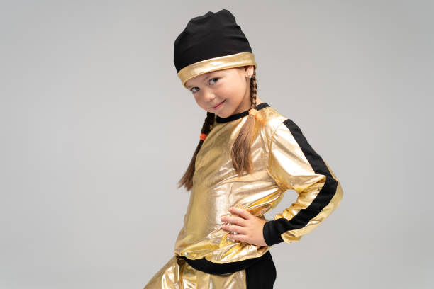 happy little girl in gold suit dancing isolated on white background. - gymnastics smiling little girls only isolated on white imagens e fotografias de stock
