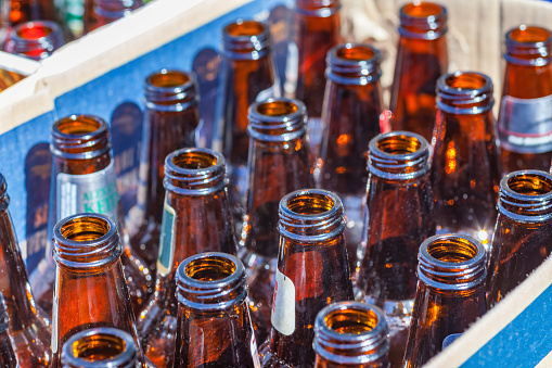 Stock photograph of beer Bottles gathered in a box for recycling
