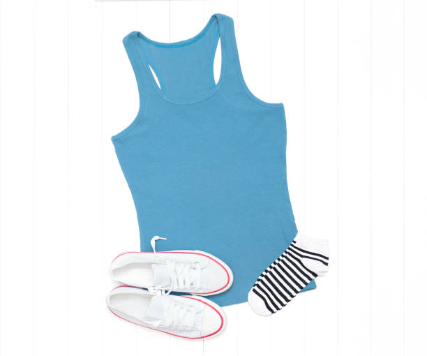 istock Blue tank top and white sneakers on a light background 1267384335