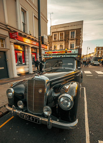 A black Mercedes-Benz 300 Sc Coupe vintage car parked on a side of a street in Notting Hill, London, England