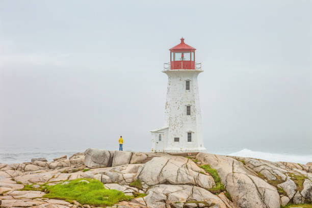 istock One person at Peggy's Cove Lighthouse Nova Scotia Canada 1267384690