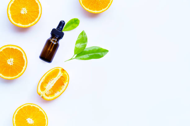 istock Orange essential oil with fresh fruits on white background. 1267385486