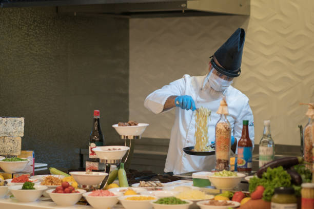 istock Chef cook wearing face protective medical mask for protection from coronavirus 1267385878