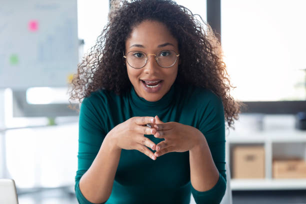 istock Beautiful young woman explaing something looking at camera in the office. 1267386901