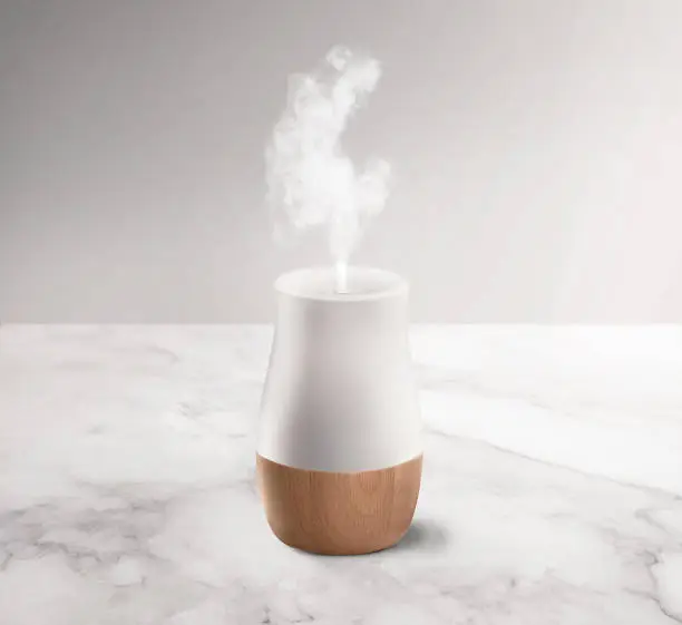 White & wood textured aroma diffuser and humidifier on a background