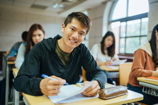 istock High school students are back to university after coronavirus pandemic. Students keep social distance in the classroom 1267387923