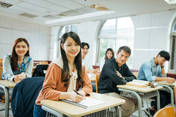 istock High school students are back to university after coronavirus pandemic. Students keep social distance in the classroom 1267387944