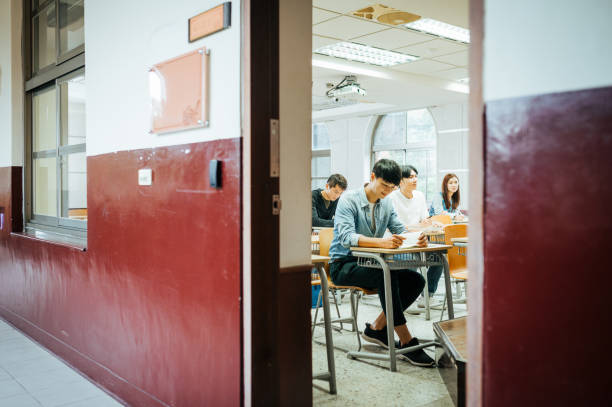 istock High school students are back to university after coronavirus pandemic. Students keep social distance in the classroom 1267387947