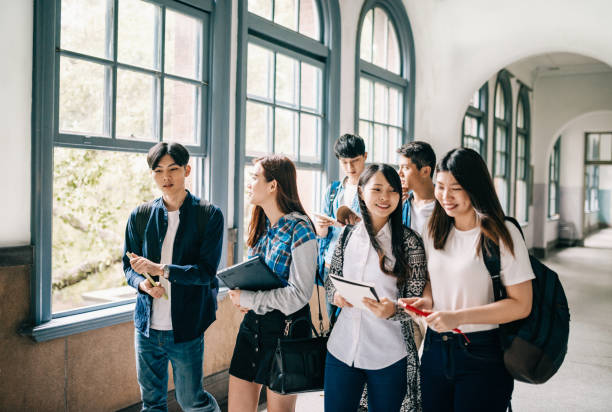 istock Students back to university, talking and discussing tasks and exams 1267388006
