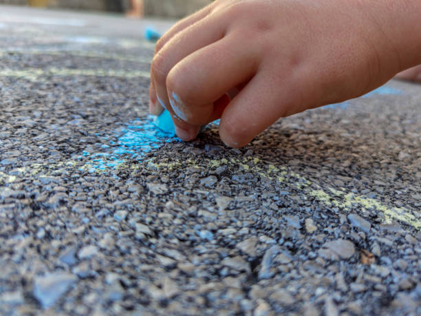 istock The child holds a chalk. close-up 1267389555