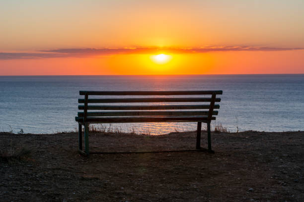 istock Bench with sea view at sunset, Sicily island, Italy 1267390482