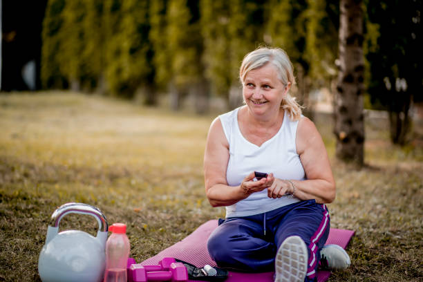 Senior woman with diabetes checking her blood glucose using glucose meter Senior woman with diabetes checking her blood glucose after workout diabetes control stock pictures, royalty-free photos & images
