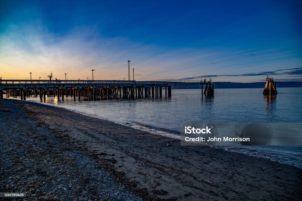 Empty ship docks at dusk on Homer spit Alaska At dusk a scenic view of empty ferry ship docks on Alaskan peninsula Homer - Alaska Stock Photo