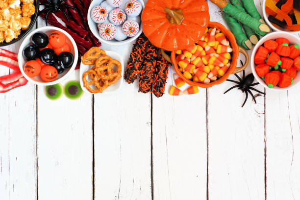 istock Halloween candy buffet top border over a white wood background 1267394570