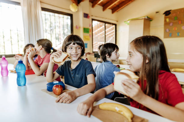 istock Elementary school children eating in the canteen 1267395576