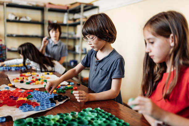 istock Elementary school children using recycled materials to protect the environment 1267395860
