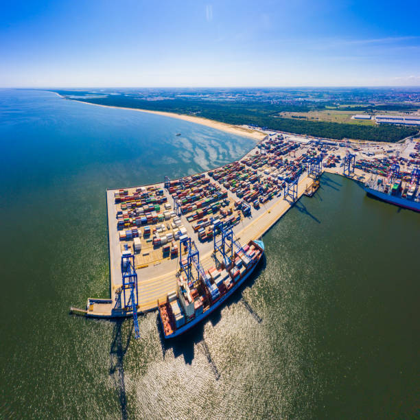 istock Container ship in export and import business and logistics. Shipping cargo to harbor by crane. Water transport International. Aerial view 1267395868