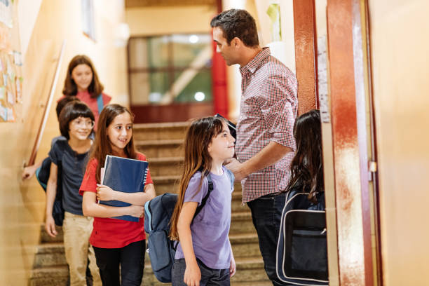 istock Elementary school children going back to school. Children keep social distance 1267395903
