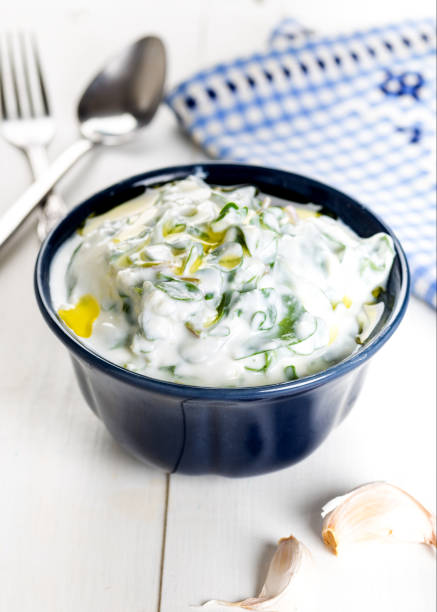 Purslane salad with yogurt in bowl on wooden background. Purslane salad with yogurt in bowl on wooden background. tzatziki stock pictures, royalty-free photos & images