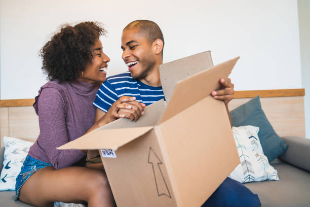 istock Young couple opening a package at home. 1267396891