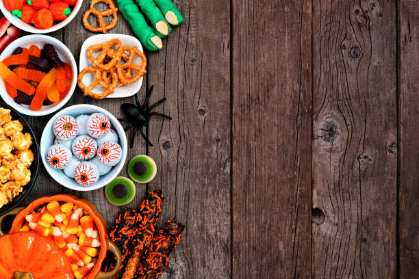 istock Halloween candy buffet side border over a rustic wood background 1267398431