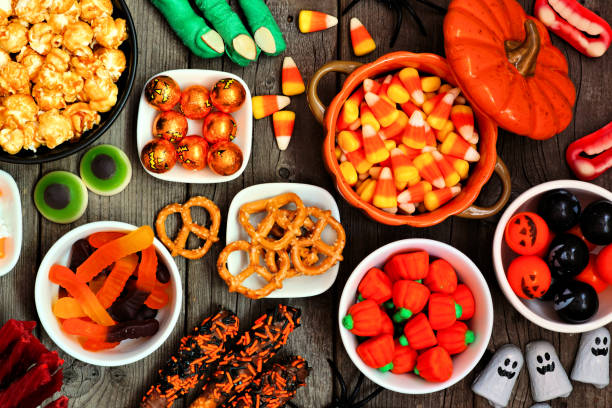 istock Halloween candy buffet table scene over a rustic wood background 1267398706
